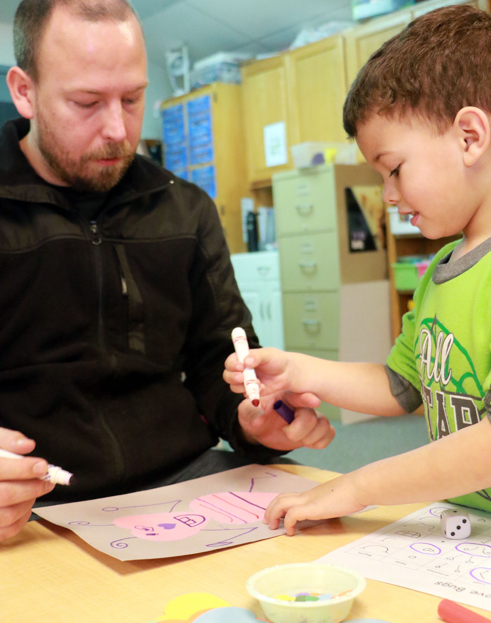 Bearcub Preschool students make Love Bugs with dad